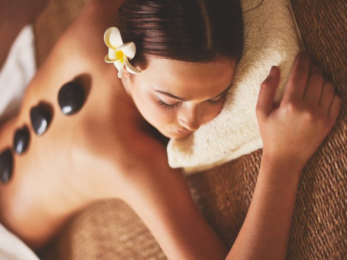 Girl receiving hot stone massage {{brizy_dc_image_alt imageSrc=